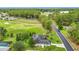 Aerial view of neighborhood near golf course showcasing mature trees, manicured landscaping, and nearby recreational amenities at 30 Lake Diamond Ave, Ocala, FL 34472