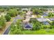 Aerial view of community showcasing mature trees, neighborhood lake, and homes with solar panels at 30 Lake Diamond Ave, Ocala, FL 34472