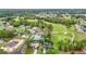 Aerial view highlighting houses on golf course surrounded by green landscape and trees at 30 Lake Diamond Ave, Ocala, FL 34472