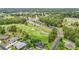 Aerial view showcasing property nestled on golf course amidst lush greenery and community at 30 Lake Diamond Ave, Ocala, FL 34472