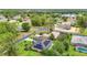 Panoramic aerial shot of a residential neighborhood featuring mature trees, lake, and homes with solar panels at 30 Lake Diamond Ave, Ocala, FL 34472