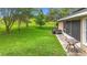 Expansive backyard featuring a lush lawn, mature trees, and a screened-in lanai perfect for outdoor enjoyment at 30 Lake Diamond Ave, Ocala, FL 34472