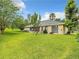 Lush backyard featuring a well-manicured lawn and a patio area ideal for outdoor entertaining at 30 Lake Diamond Ave, Ocala, FL 34472