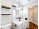 Bathroom featuring a modern vanity and decorative floating shelves at 30 Lake Diamond Ave, Ocala, FL 34472