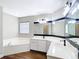 Bright bathroom with a double vanity, soaking tub, and sleek fixtures at 30 Lake Diamond Ave, Ocala, FL 34472