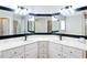Bathroom featuring double sinks, white cabinetry, gold hardware, and updated light fixtures at 30 Lake Diamond Ave, Ocala, FL 34472