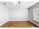 Bright bedroom featuring hardwood floors and a modern light fixture at 30 Lake Diamond Ave, Ocala, FL 34472
