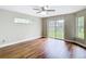 Comfortable bedroom with neutral walls, ceiling fan, and lots of light at 30 Lake Diamond Ave, Ocala, FL 34472