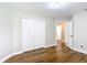 Bedroom featuring wood floors, a closet for ample storage, and an open door to hallway at 30 Lake Diamond Ave, Ocala, FL 34472