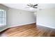 Light-filled bedroom with hardwood floors, ceiling fan, and neutral walls at 30 Lake Diamond Ave, Ocala, FL 34472
