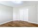 Bedroom featuring wood flooring, white walls and trim, and closet space at 30 Lake Diamond Ave, Ocala, FL 34472