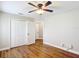 Bedroom featuring wood flooring, a ceiling fan, and a large closet at 30 Lake Diamond Ave, Ocala, FL 34472