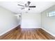 A large bedroom featuring hardwood floors, neutral walls, and ceiling fan at 30 Lake Diamond Ave, Ocala, FL 34472