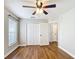 Bedroom showcasing wood flooring, closet space, neutral walls, and window with blinds at 30 Lake Diamond Ave, Ocala, FL 34472