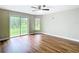 Large bedroom featuring hardwood floors, ceiling fan, and sliding glass door at 30 Lake Diamond Ave, Ocala, FL 34472