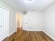Bright bedroom showcasing wood floors, open door to hallway, and closet for ample storage at 30 Lake Diamond Ave, Ocala, FL 34472