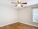 Bedroom showcasing wood flooring, ceiling fan, neutral walls, and a window with blinds at 30 Lake Diamond Ave, Ocala, FL 34472