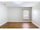 Bright bedroom with hardwood floors, neutral walls, and a window with blinds at 30 Lake Diamond Ave, Ocala, FL 34472
