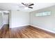 A large bedroom with hardwood floors, ceiling fan, and view of entry hall at 30 Lake Diamond Ave, Ocala, FL 34472