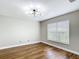 Bright bedroom featuring hardwood floors and a modern light fixture at 30 Lake Diamond Ave, Ocala, FL 34472