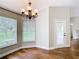 Dining room features hardwood floors, a modern chandelier, and bright windows, creating an inviting atmosphere at 30 Lake Diamond Ave, Ocala, FL 34472