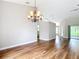 Dining area featuring hardwood floors, a chandelier, and an open layout perfect for entertaining guests at 30 Lake Diamond Ave, Ocala, FL 34472