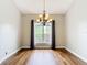 Dining room with hardwood floors, a chandelier, and large windows providing ample natural light at 30 Lake Diamond Ave, Ocala, FL 34472