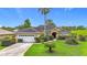 Inviting one-story home featuring a manicured lawn and a two-car garage at 30 Lake Diamond Ave, Ocala, FL 34472