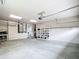 Spacious garage with two car garage doors, high ceilings, bright interior and added storage at 30 Lake Diamond Ave, Ocala, FL 34472
