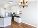 Modern kitchen combines white cabinets, stainless appliances, and a breakfast bar for a sleek and functional space at 30 Lake Diamond Ave, Ocala, FL 34472