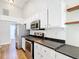 Modern kitchen with stainless appliances, white cabinets, sleek countertops, and contemporary backsplash offers a functional layout at 30 Lake Diamond Ave, Ocala, FL 34472