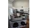 Efficient kitchen featuring white cabinetry, modern stainless steel appliances, and a bar with seating at 30 Lake Diamond Ave, Ocala, FL 34472