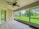 Lanai featuring ceiling fan, screened windows with an inviting view of the backyard and pool at 30 Lake Diamond Ave, Ocala, FL 34472