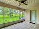 Lanai featuring ceiling fan, screened windows with an inviting view of the backyard at 30 Lake Diamond Ave, Ocala, FL 34472