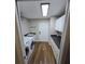 Functional laundry room with modern washer/dryer, sink, and storage for cleaning supplies at 30 Lake Diamond Ave, Ocala, FL 34472