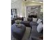Comfortable living room featuring stylish sectional seating and bright natural light at 30 Lake Diamond Ave, Ocala, FL 34472