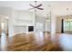 Bright living room featuring hardwood floors, a fireplace, and a ceiling fan, perfect for a cozy atmosphere at 30 Lake Diamond Ave, Ocala, FL 34472