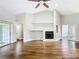 Open living room with hardwood floors, a fireplace, and sliding glass doors leading to an outdoor area at 30 Lake Diamond Ave, Ocala, FL 34472