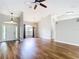 Bright living room featuring hardwood floors, a ceiling fan, and a chandelier, great for entertaining at 30 Lake Diamond Ave, Ocala, FL 34472
