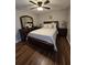 Comfortable main bedroom featuring a full dresser set, ample closet space, and wood flooring at 30 Lake Diamond Ave, Ocala, FL 34472