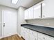 Pantry features granite countertops, modern white cabinets, and hardwood floors at 30 Lake Diamond Ave, Ocala, FL 34472