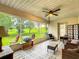 Enclosed sunroom with views of the green space and tiled flooring, perfect for relaxation at 30 Lake Diamond Ave, Ocala, FL 34472
