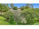 Landscaped yard with mature trees and flowering shrubs creating a serene and inviting outdoor space at 30 Lake Diamond Ave, Ocala, FL 34472