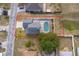 An aerial view of a single-Gathering home showcasing a screened-in pool and a neatly fenced-in backyard at 3647 Minute Maid Ramp Rd 1 Rd, Davenport, FL 33837