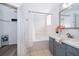 Bathroom features a bathtub and a vanity with light blue cabinets at 3647 Minute Maid Ramp Rd 1 Rd, Davenport, FL 33837
