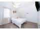 Bright bedroom with a ceiling fan, a window and light colored walls and flooring at 3647 Minute Maid Ramp Rd 1 Rd, Davenport, FL 33837