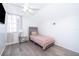 Cozy bedroom with light-colored walls, natural light, and modern gray flooring and headboard at 3647 Minute Maid Ramp Rd 1 Rd, Davenport, FL 33837
