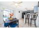 Open-concept dining area with a modern table set, stylish seating, and seamless access to the screened-in pool area at 3647 Minute Maid Ramp Rd 1 Rd, Davenport, FL 33837