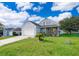 Picture of a lovely home featuring a well-kept lawn, charming landscaping, and a welcoming entryway at 3647 Minute Maid Ramp Rd 1 Rd, Davenport, FL 33837