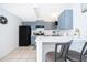 Eat-in kitchen features a breakfast bar and light blue cabinets at 3647 Minute Maid Ramp Rd 1 Rd, Davenport, FL 33837